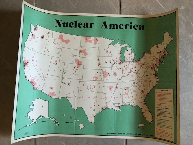 A map of the United States is spotted with red blobs that  indicate all of the places where nuclear testing has happened. A title above the map reads “Nuclear America.”