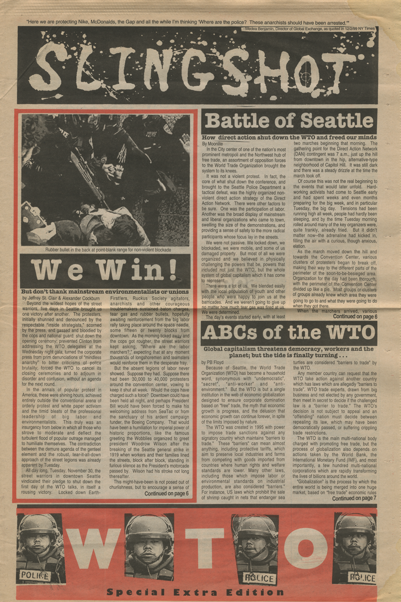 Anews publication, “SLINGSHOT.” The page has three short articles, titled “We Win!” “Battle of Seattle,” and “ABCs of the WTO”. There is a red rectangle on the bottom of the page which has white letters which spell WTO. In between each letter is a photograph of a police officer’s face.